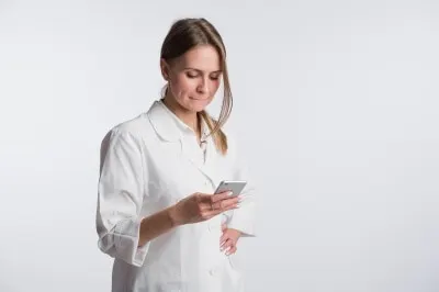 doctor using secure texting on mobile device