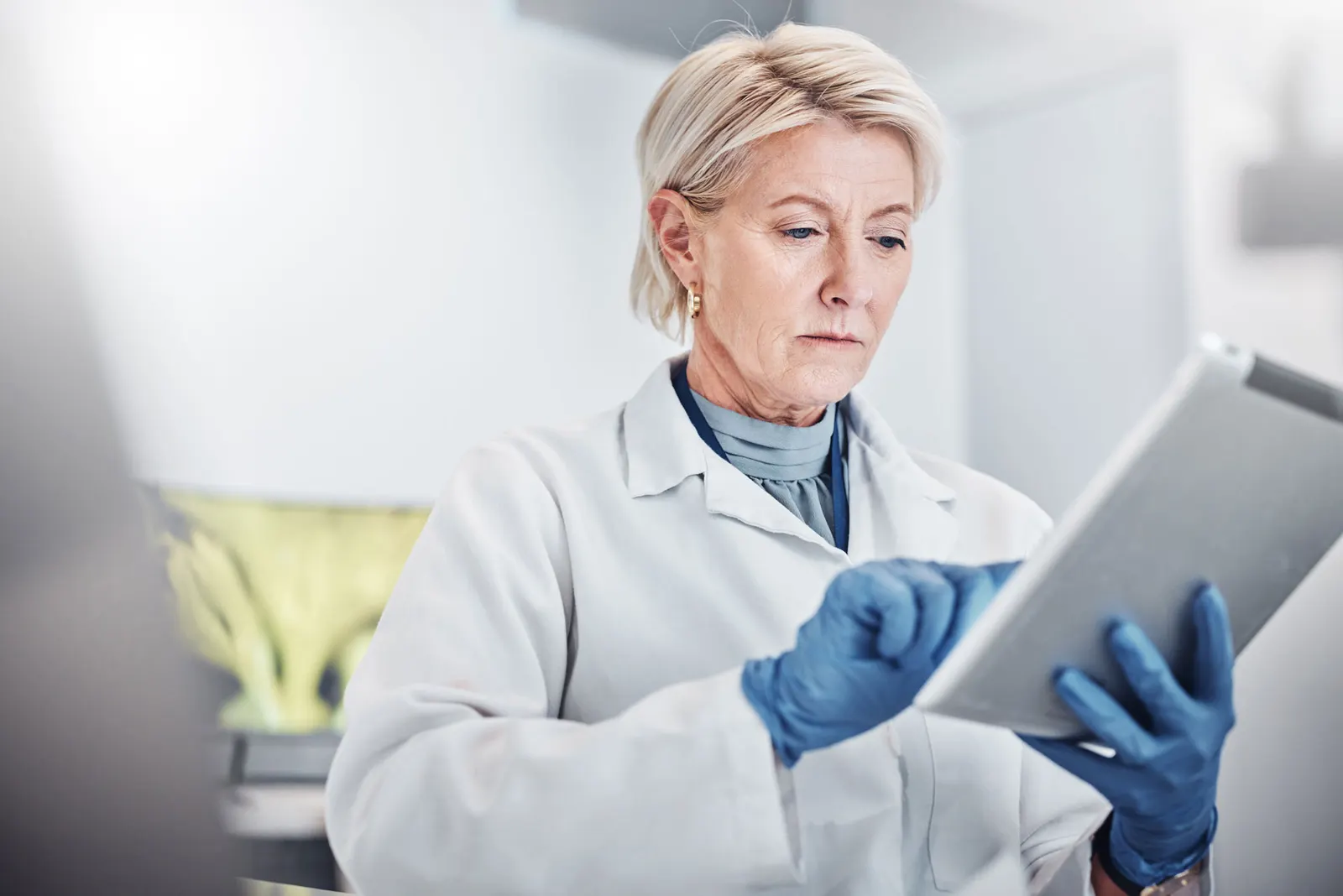A doctor selecting an option on a ipad. 